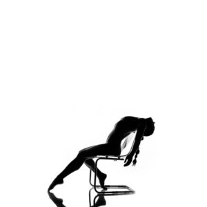 A silhouette of a woman sitting on a chair.