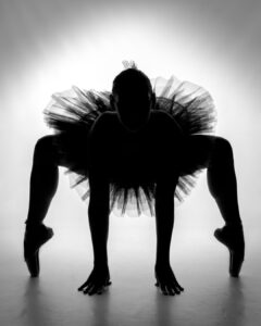 A silhouette of a woman in a tutu.